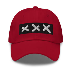 A classic XXX Dad Cap in red, showcasing a black rectangular patch with three white embroidered Amsterdam Crosses in a row on the front.
