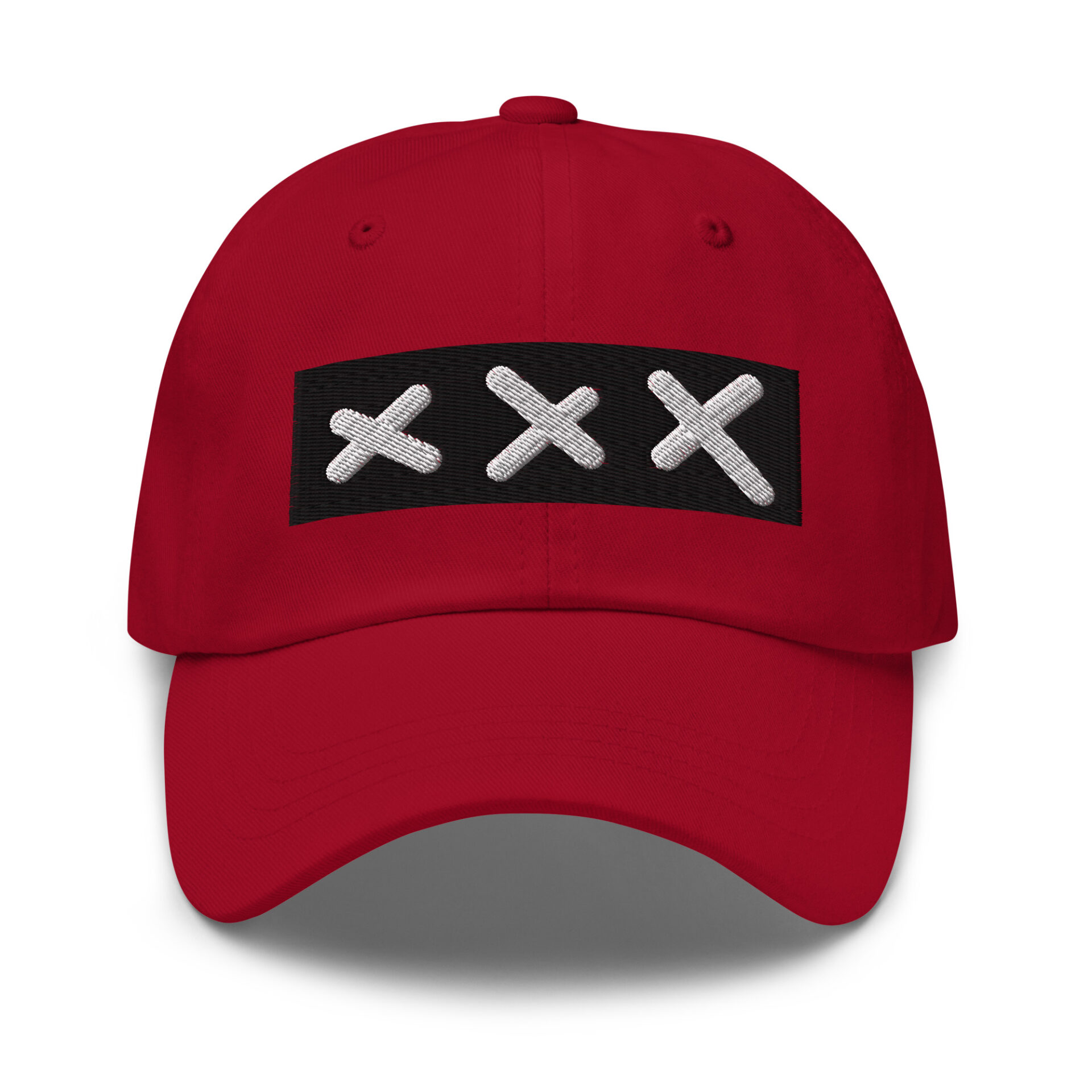 A classic XXX Dad Cap in red, showcasing a black rectangular patch with three white embroidered Amsterdam Crosses in a row on the front. A classic XXX Dad Cap in red, showcasing a black rectangular patch with three white embroidered Amsterdam Crosses in a row on the front.