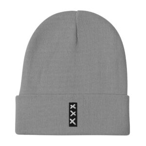 Introducing the SUBTLE & MIGHTY XXX (3 Amsterdam Crosses) embroidered Beanie—a gray knit beanie with a folded brim, adorned on the front with a small black patch showcasing three vertically arranged white Xs, subtly inspired by the iconic Amsterdam Crosses. This beanie captures a SUBTLE & MIGHTY vibe, making it an effortless addition to any outfit.