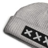 A close-up of the XXX embroidered FISHERMAN Beanie - Bold & Brave in gray, showcasing its bold knit and a black patch with three white stitched Xs in a row on the folded brim. A close-up of the XXX embroidered FISHERMAN Beanie - Bold & Brave in gray, showcasing its bold knit and a black patch with three white stitched Xs in a row on the folded brim.