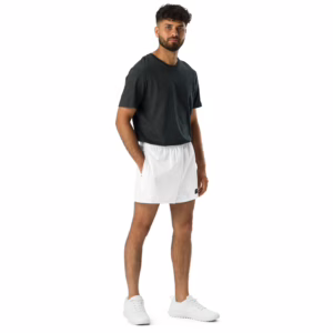 A person stands against a white background wearing a dark gray t-shirt, All-Over Print Unisex Athletic Shorts, and white sneakers. They pose with one leg forward and hands relaxed by their sides.