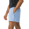 A person in a charcoal gray t-shirt and MJL Athletic Shorts, light blue, stands with hands in pocket; shown from shoulders to mid-thigh on a white background. A person in a charcoal gray t-shirt and MJL Athletic Shorts, light blue, stands with hands in pocket; shown from shoulders to mid-thigh on a white background.