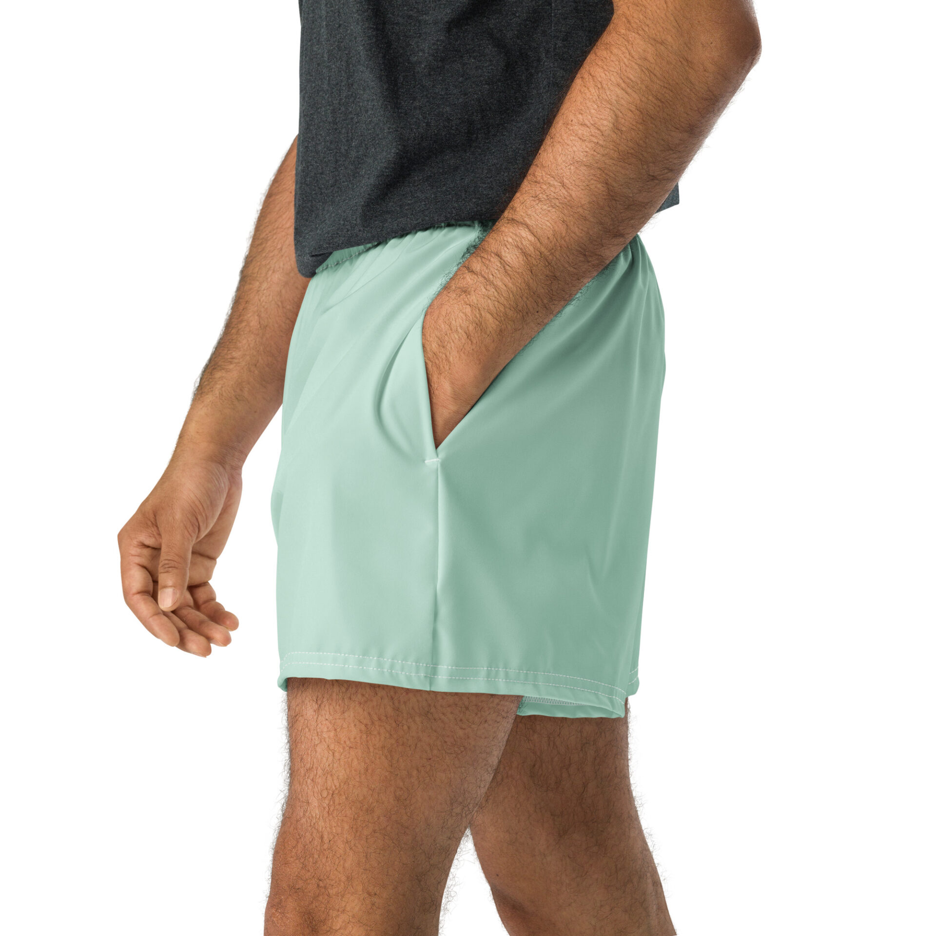 A person shown from the waist down against a white background wears light green MJL Athletic Shorts with one hand in the pocket and a dark grey shirt. A person shown from the waist down against a white background wears light green MJL Athletic Shorts with one hand in the pocket and a dark grey shirt.
