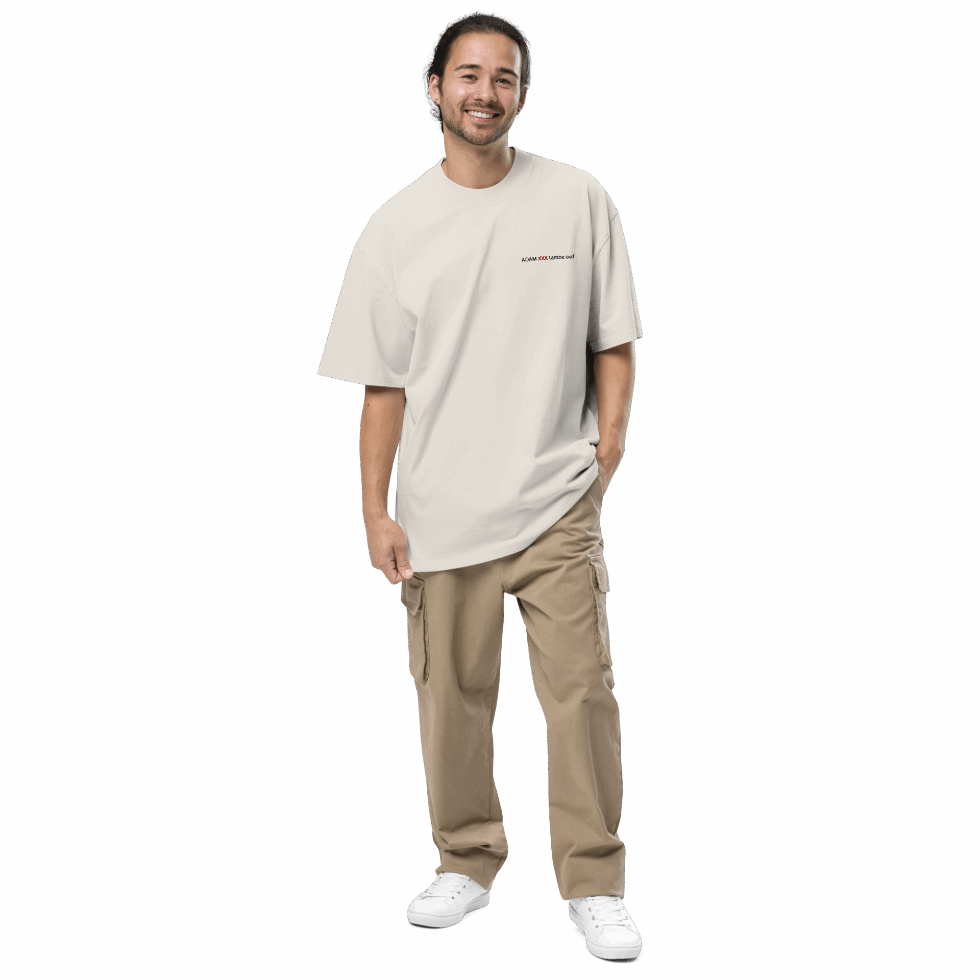 A man with long dark hair tied back is smiling and wearing an ADAM XXX TANTOE OUD Oversized faded t-shirt, khaki cargo pants, and white sneakers, standing with one hand in his pocket against a plain dark background. A man with long dark hair tied back is smiling and wearing an ADAM XXX TANTOE OUD Oversized faded t-shirt, khaki cargo pants, and white sneakers, standing with one hand in his pocket against a plain dark background.