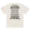 An oversized faded t-shirt in white featuring bold black text on the back with motivational phrases about dreams, including "You have to eat the dream, sleep the dream," and "You gotta be possessed with the dream. An oversized faded t-shirt in white featuring bold black text on the back with motivational phrases about dreams, including "You have to eat the dream, sleep the dream," and "You gotta be possessed with the dream.