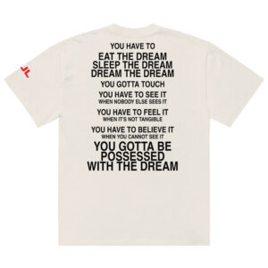An oversized faded t-shirt in white featuring bold black text on the back with motivational phrases about dreams, including "You have to eat the dream, sleep the dream," and "You gotta be possessed with the dream.