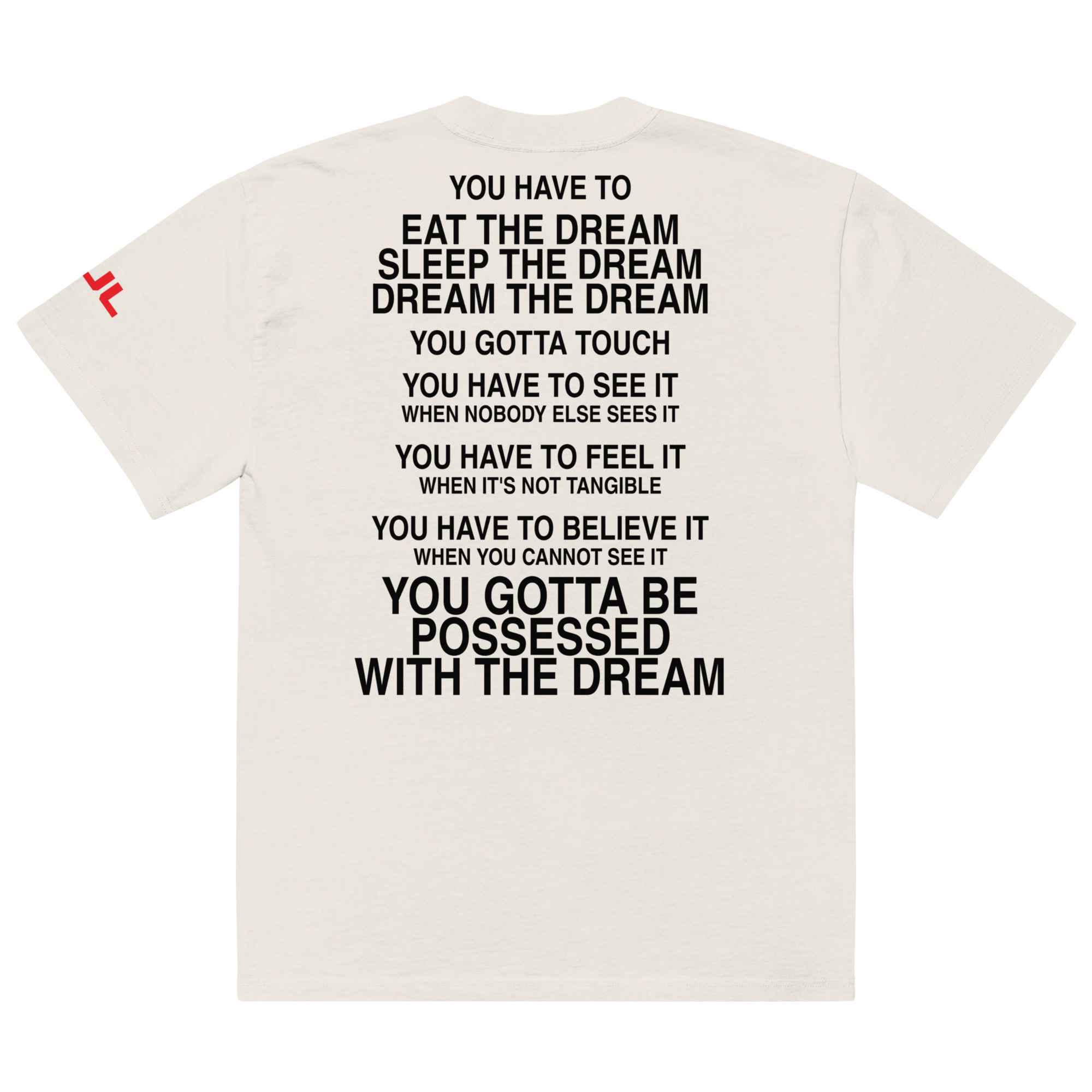 An oversized faded t-shirt in white featuring bold black text on the back with motivational phrases about dreams, including "You have to eat the dream, sleep the dream," and "You gotta be possessed with the dream. An oversized faded t-shirt in white featuring bold black text on the back with motivational phrases about dreams, including "You have to eat the dream, sleep the dream," and "You gotta be possessed with the dream.